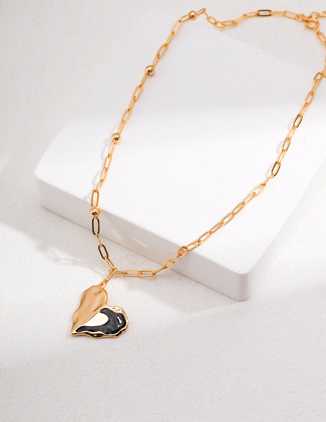 Radiant Love: Black Enamel Pure Silver Heart Necklace in Platinum and Vintage Gold